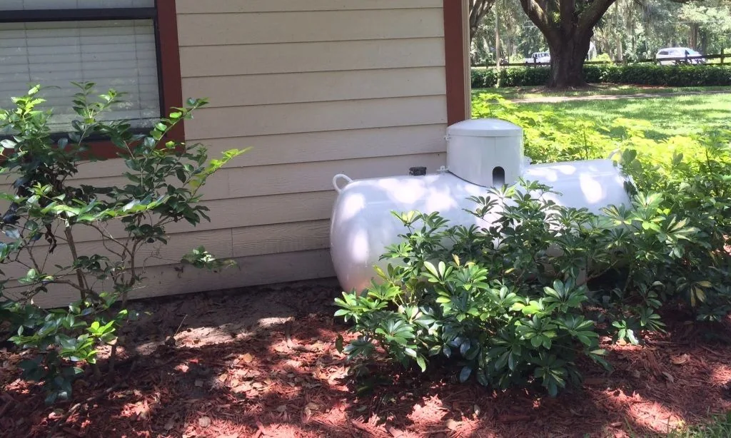 Residential propane tank on a landscaped property