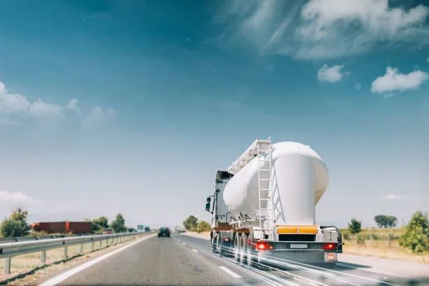 Bulk propane tanker traveling on a highway for fleet fuel logistics