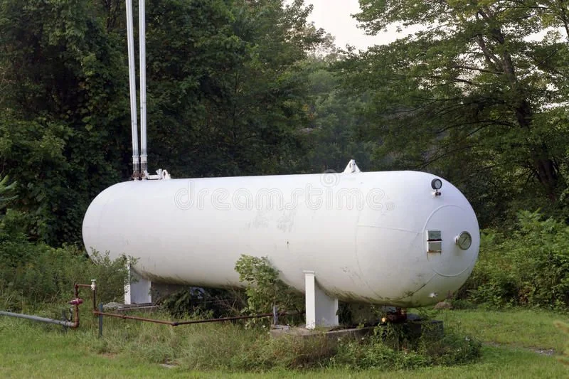 Large white propane tank installed beside a property