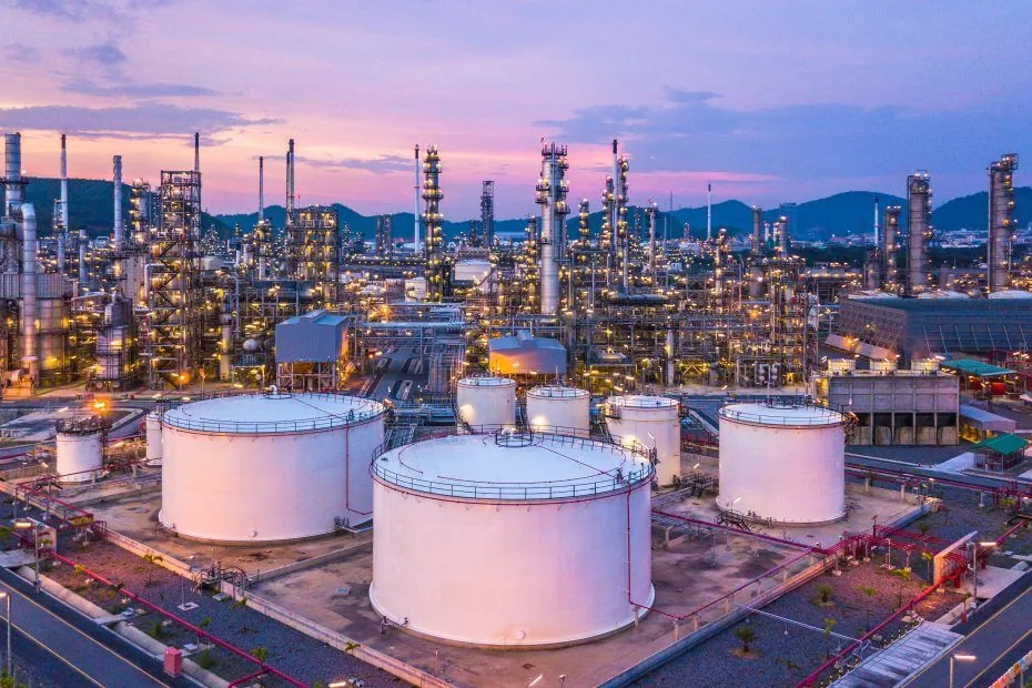 Large industrial energy terminal with storage tanks at sunset