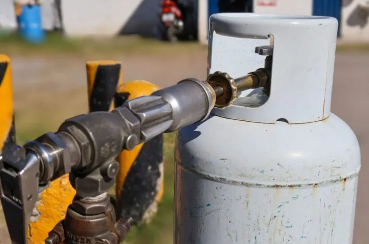 Propane cylinder connected to refueling equipment