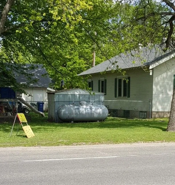Propane tank beside a property representing propane service applications